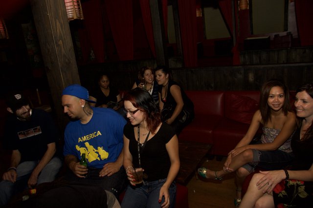 Friends Gathering at a Dimly Lit Nightclub Lounge