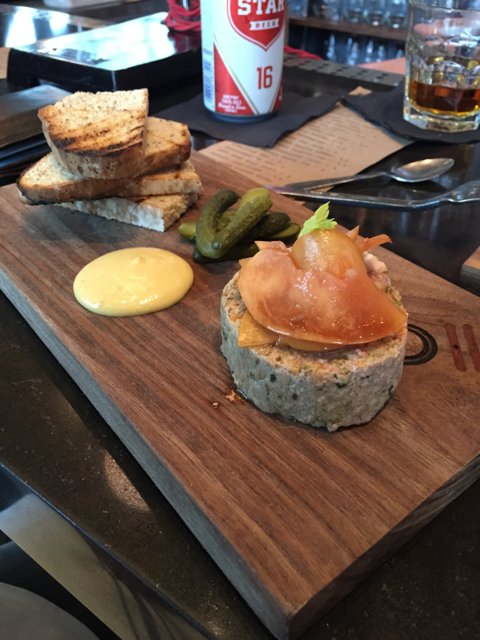 Delicious Sandwich and Pickles on a Wooden Cutting Board