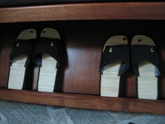 Black and White Sandals on Wooden Shelf