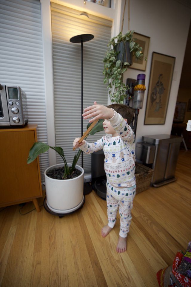 Child in Holiday Pajamas Playing Indoors