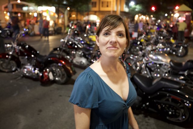 Woman Amid Motorcycles at Night Street Rally