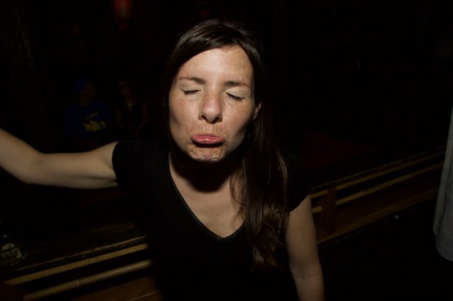 Woman Making a Playful Face at Night Event