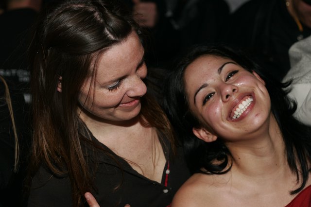 Two Women Laughing Together at Nighttime Event