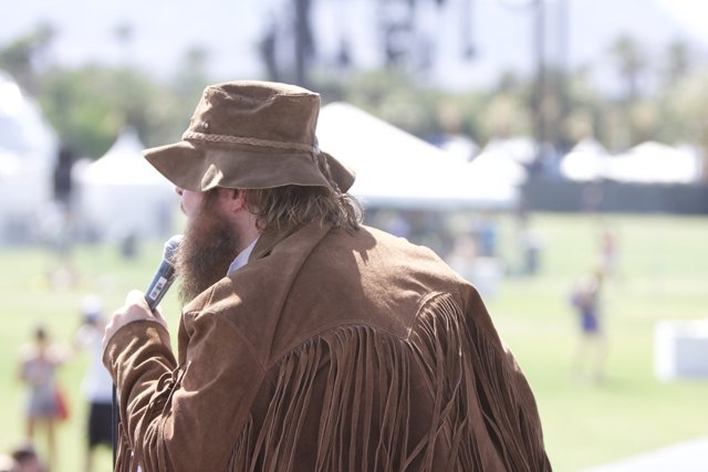 Hat-Wearing Man Addresses the Crowd at Coachella