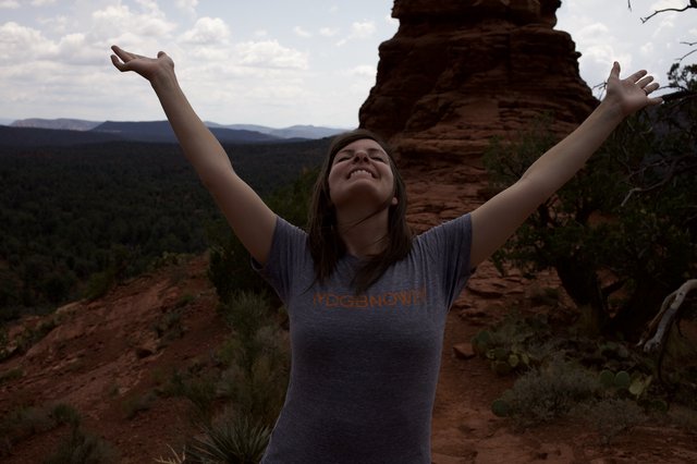 Joyful Woman Celebrates Atop Sedona Red Rock