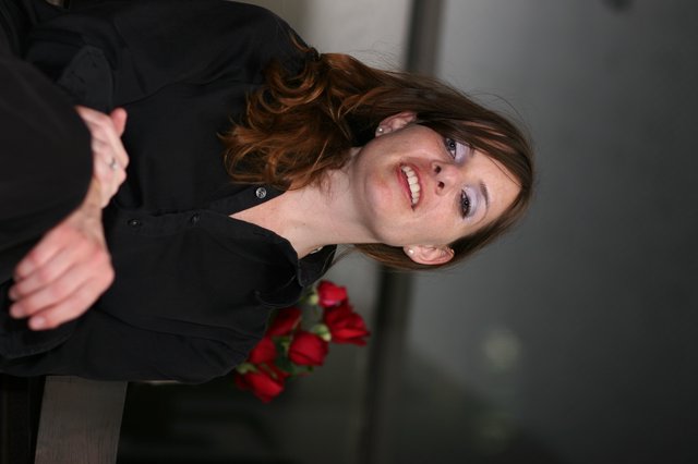 Penelope Smiling with Red Roses in Office