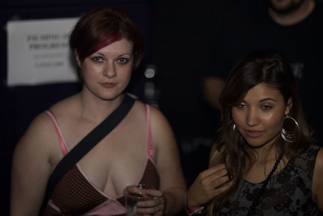 Two Women in Evening Dresses at a Party