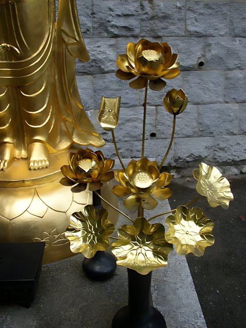 Golden Buddha with Floral Offerings