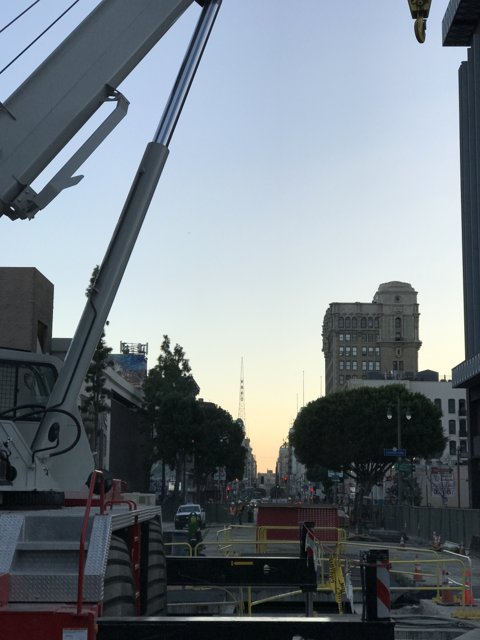 Construction Crane Lifting Equipment onto Busy Los Angeles Street