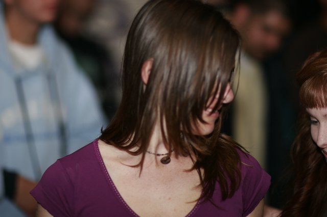 Hair Cascading Over Face at Indoor Gathering