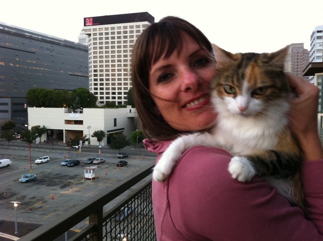 Woman and Calico Cat on Urban Balcony Selfie