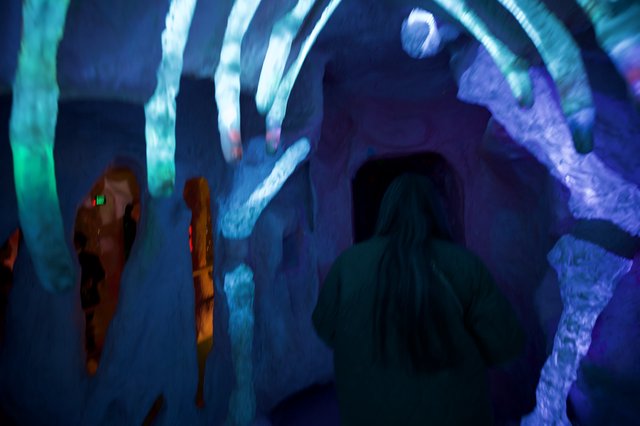 Visitors in Ice Cave with Blue Projected Light