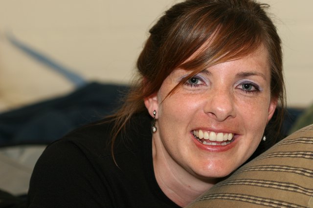 Radiant Woman Smiling Candidly on Living Room Sofa