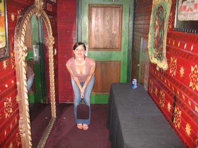 Woman Posing in Eclectic Red-Walled Venue Hallway