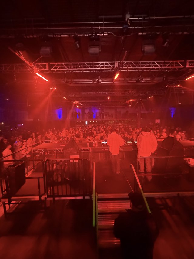 Electronic Music Event with Red Stage Lighting and Crowd