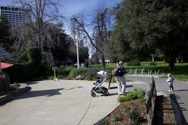 Family Afternoon Stroll Through Urban Park Gardens