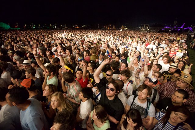Crowd Dancing under the Night Sky at Coachella Festival