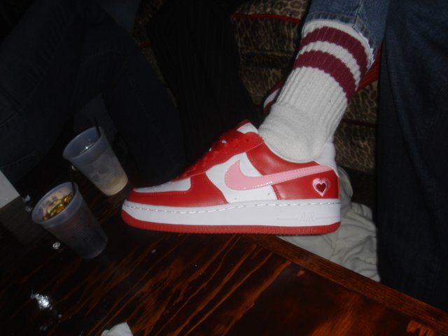 Red and White Nike Shoe on Hardwood