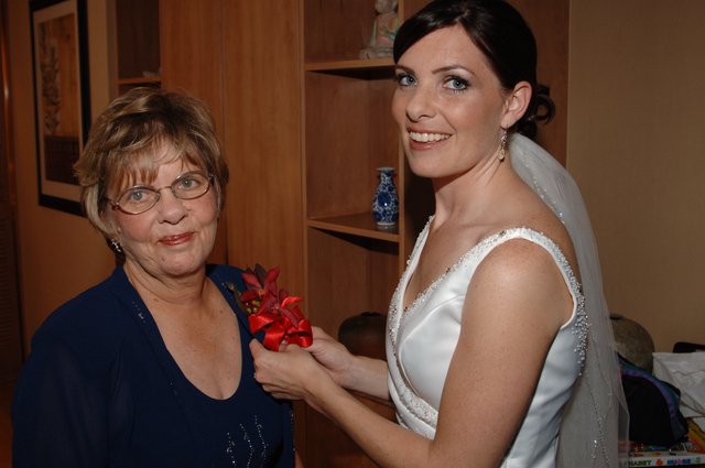Bride Pins Corsage on Mother Before Wedding Ceremony