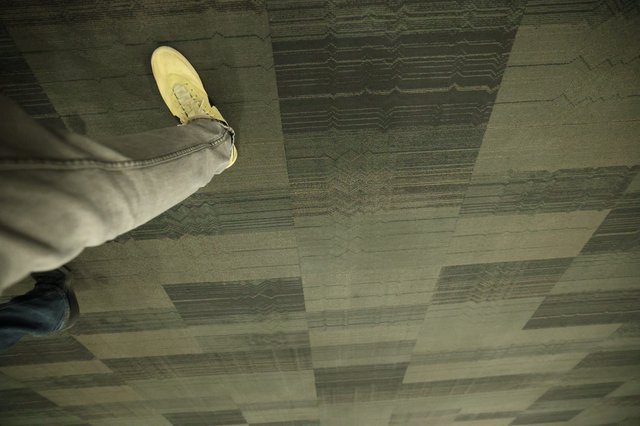 Mid-Step: Sneaker Over Patterned Carpet Tiles