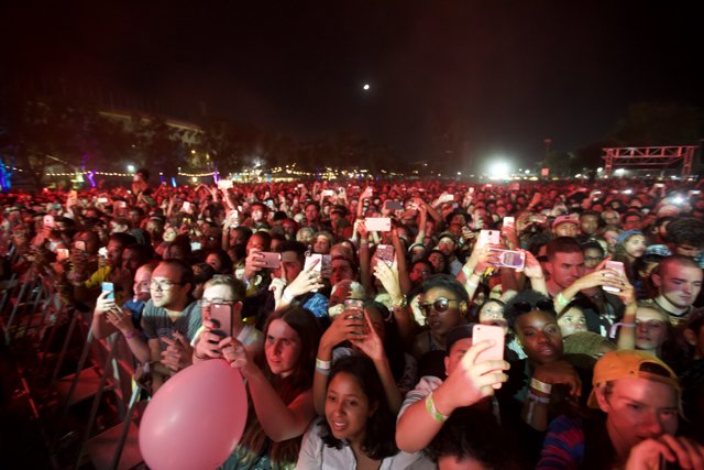 Capturing the Moment: Concertgoers Take Photos Under the Night Sky