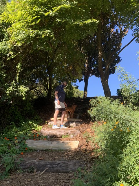 Man and his faithful companion climb the stairs in Golden Gate Park