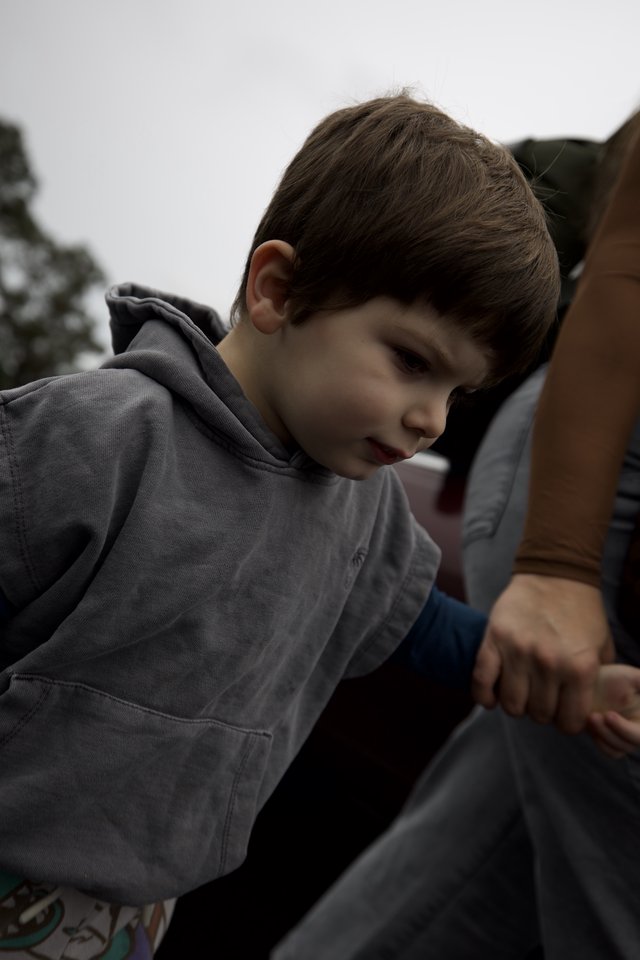 Young Boy in Thoughtful Moment at Indoor Setting