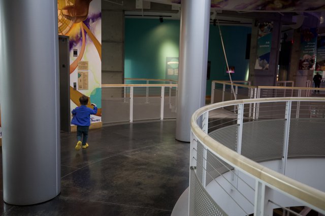Young Explorer in Modern Science Museum Walkway