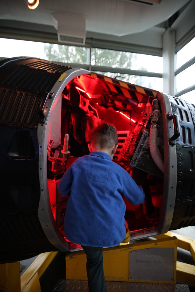 Child Exploring Illuminated Aerospace Engine Display