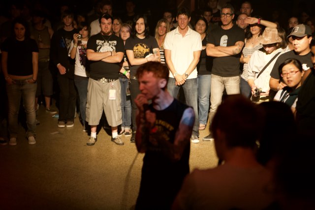 Tattooed Man Rocks Out with Crowd