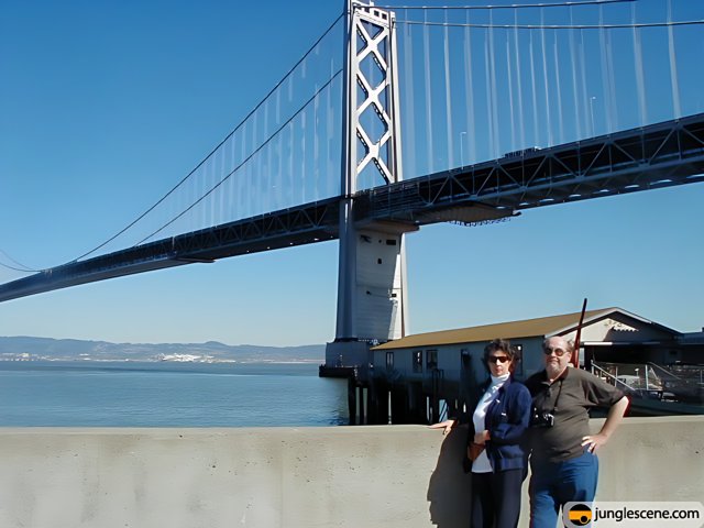 Two Men Enjoying the View from the Bridge