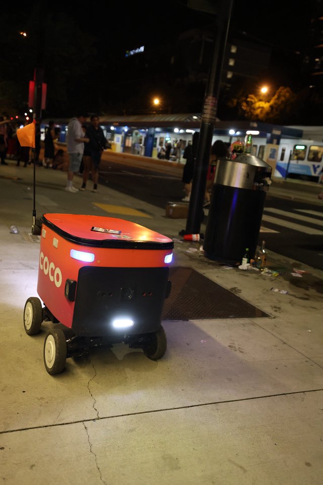 Coco Delivery Robot Navigates Busy City Sidewalk at Night