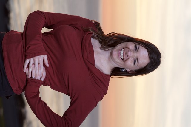 Joyful Woman Laughing at Coastal Sunset