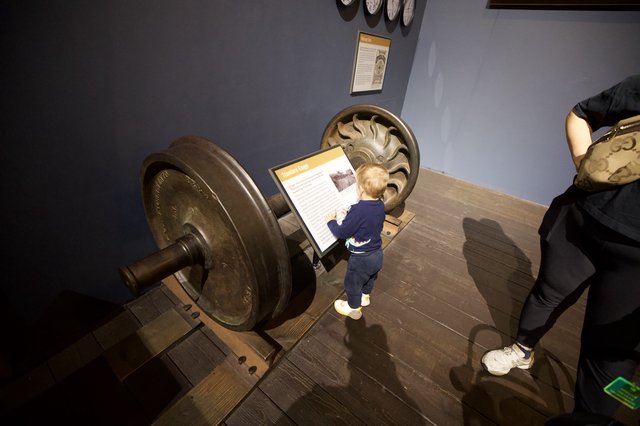 Young Child Explores Interactive Museum Display