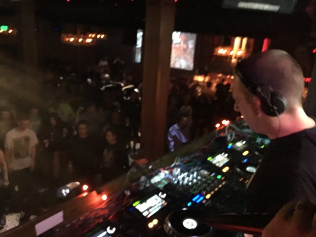Nightclub DJ Performs for Enthusiastic Crowd