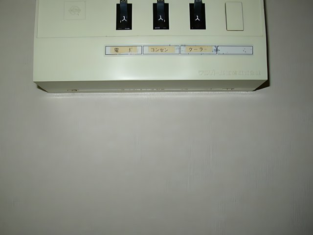 Four Switches on a White Electrical Panel