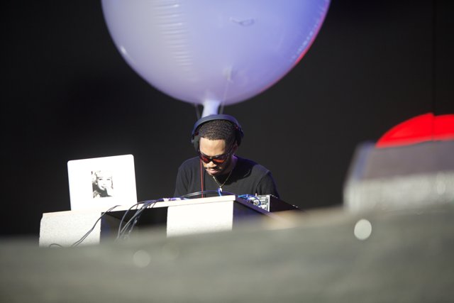 Man on Laptop Surrounded by Balloons at Coachella