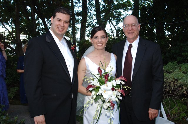 Joyful Wedding Trio Portrait in Garden Setting