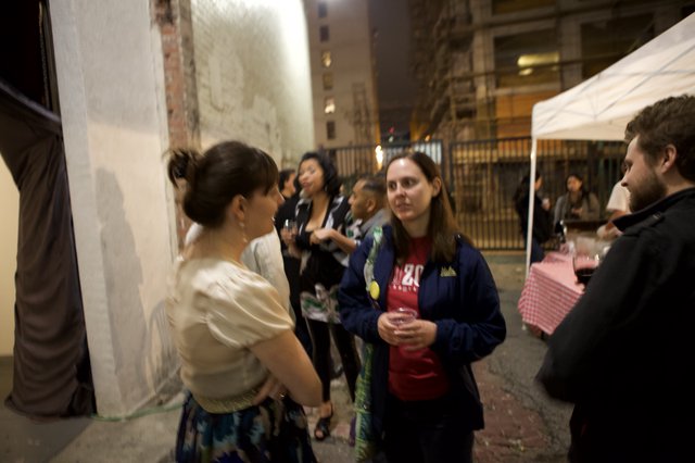 Nighttime Wine Party Gathering in Urban Alleyway