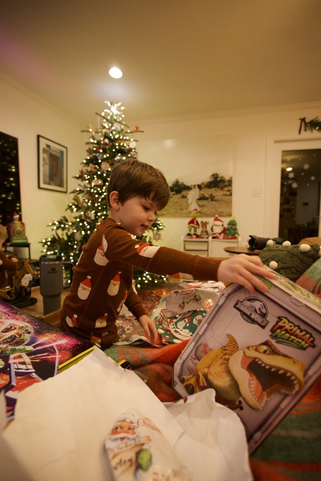 Young Boy Opening Christmas Presents on Holiday Morning