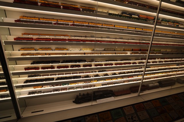 Extensive Model Train Collection Display Wall with Illuminated Shelving