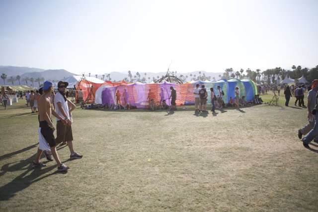 Festival Goers Take Shelter Under Colorful Tent
