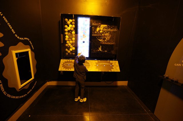 Child Exploring Interactive Space Exhibit at Science Museum