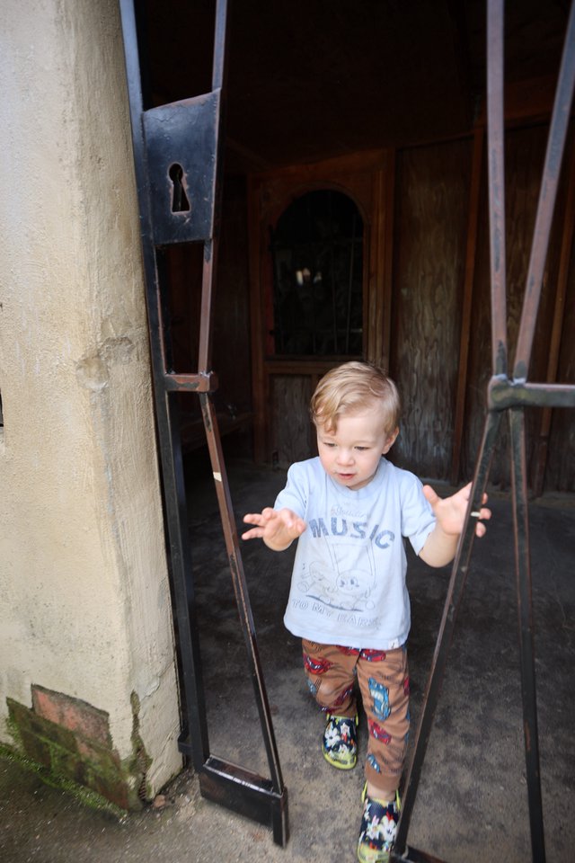 Young Boy Stepping Through Historic European Doorway