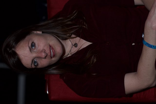 Woman in Red Chair with Pensive Gaze