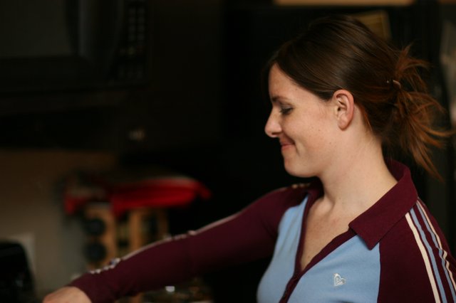 Young Woman Smiling in Burgundy Track Jacket