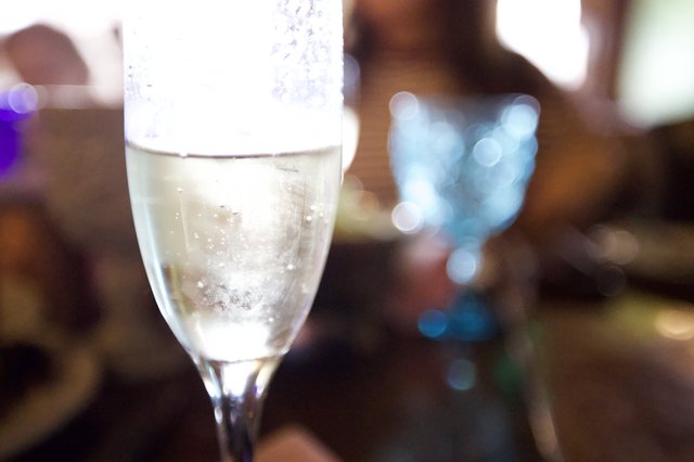 Sparkling Champagne Flute with Bokeh Light Effects
