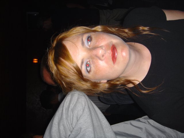 Redhead Woman with Blue Eyes at Night Event