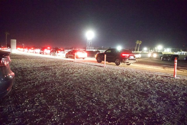 Midnight Exodus: Vehicles Under Starlit Coachella Sky