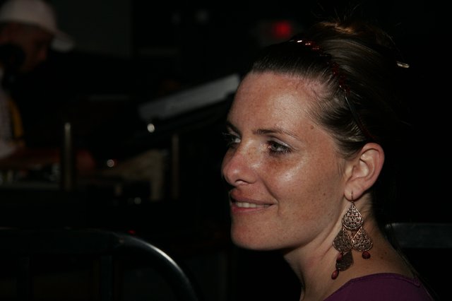 Woman in Profile Smiling at Nighttime Event